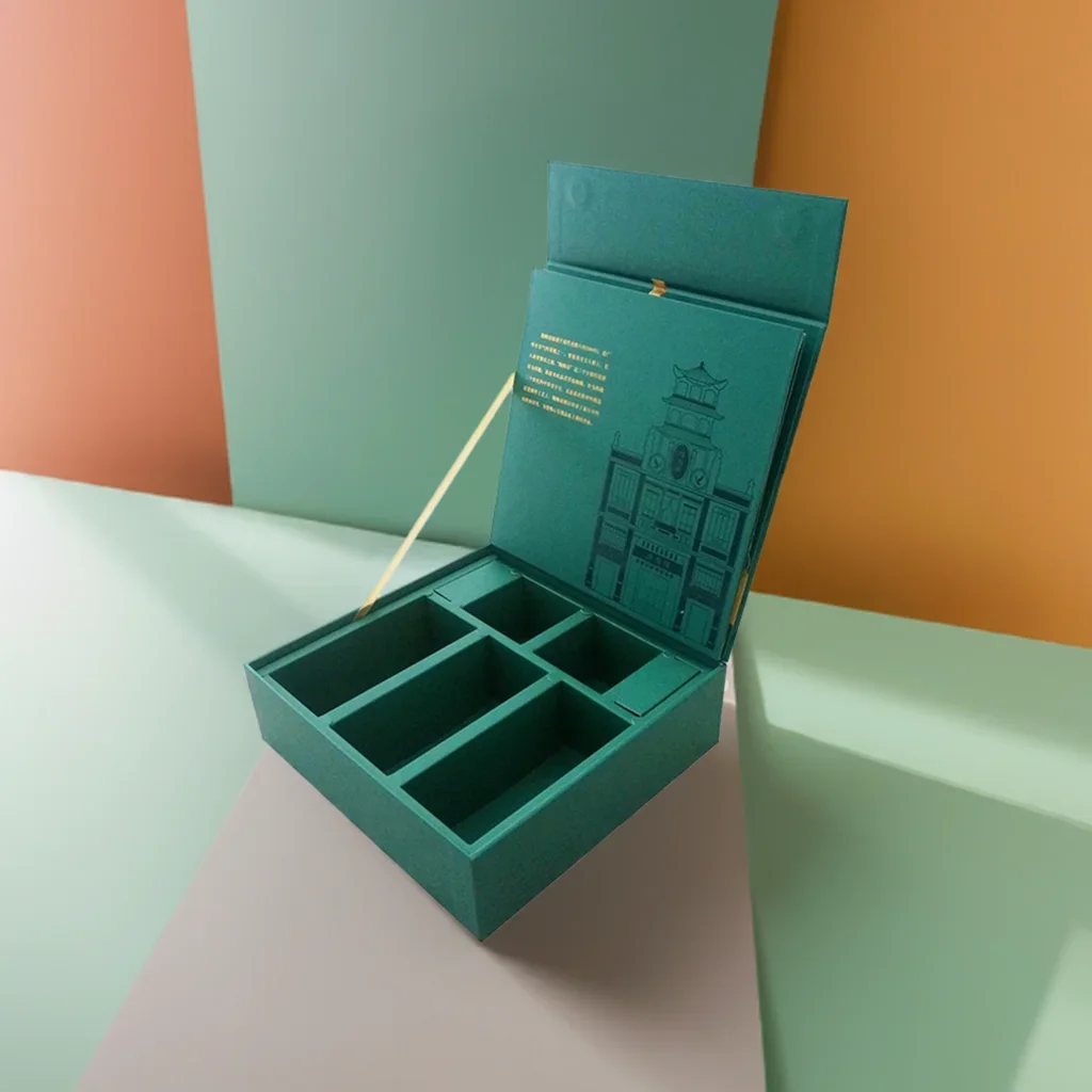 A premium teal-colored custom rigid box for corporate gifts featuring an elegant architectural illustration on the inner lid and multiple internal compartments.